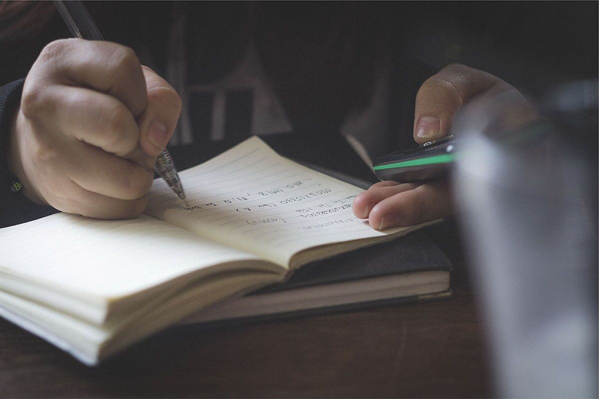Background image of someone writing